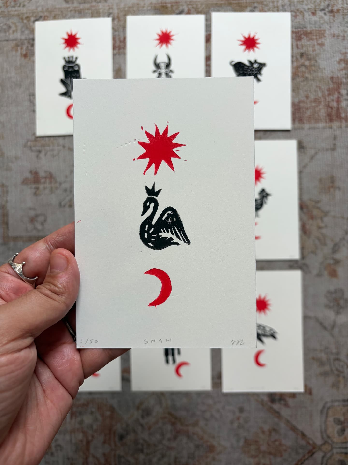 Hand holding a celestial lino print