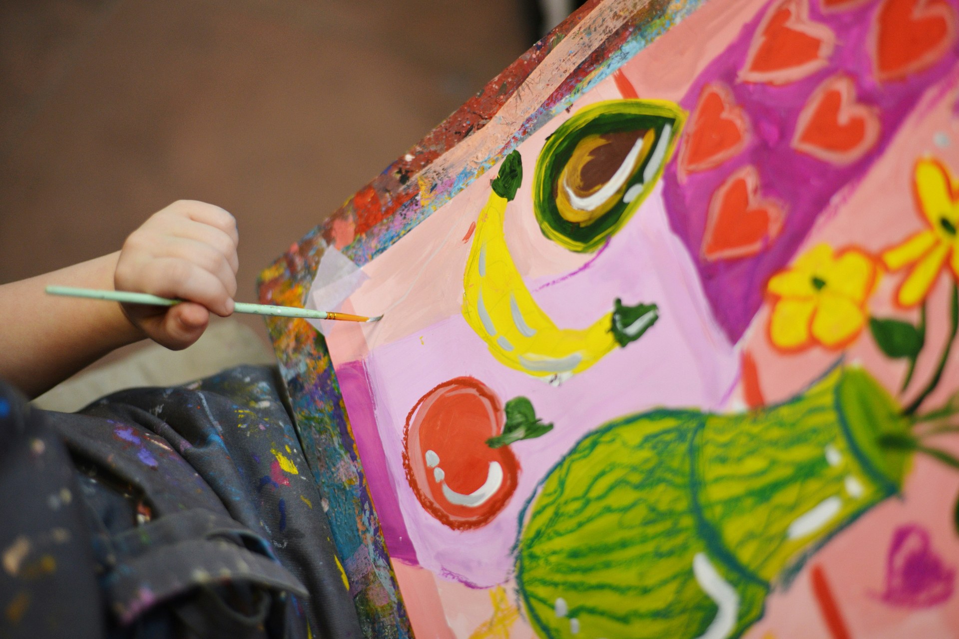 Child painting on a large sheet of paper